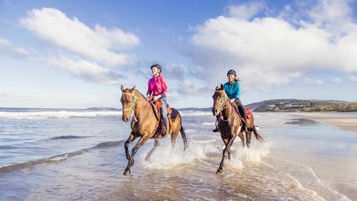Horse riding on Rainbow Beach. Picture Visit Sunshine Coast. 